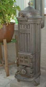 Orangeri med peis En vedovn settes op i orangeriet